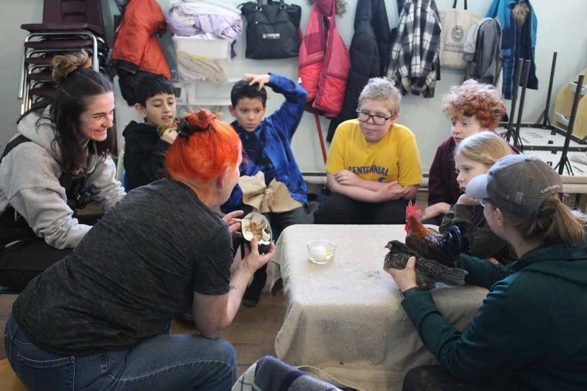 Participants during animal interaction, comparing the size of different eggs.