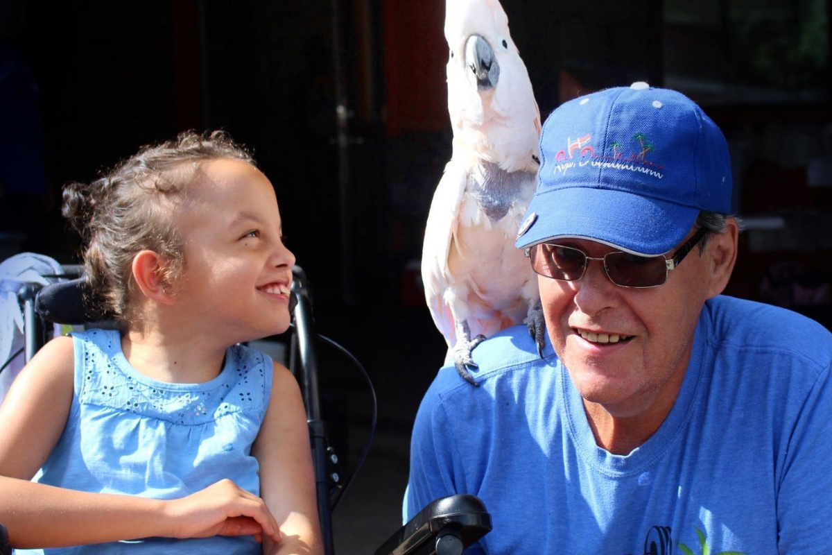 One of our guests beside Dave with a bird on his shoulder.