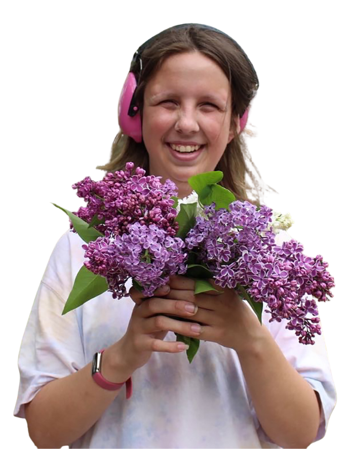 Participant smiling with bouquet of flowers.