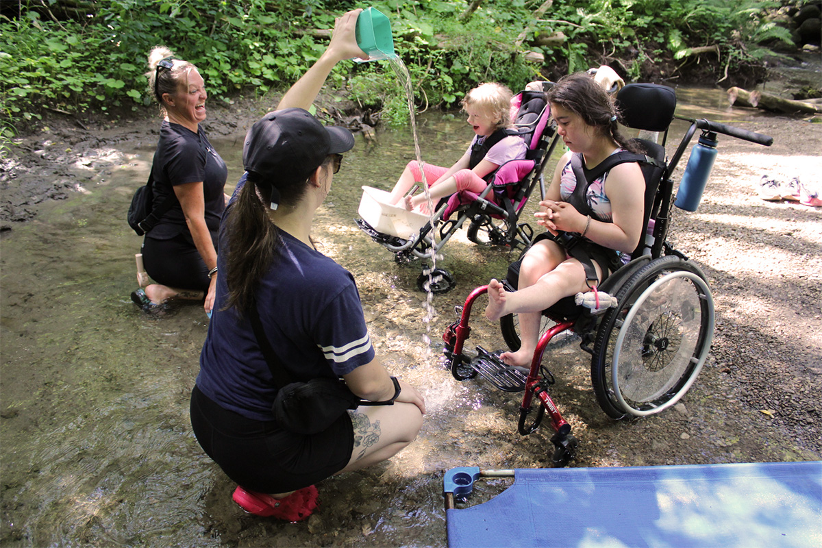 Participants and their mentors at the creek.