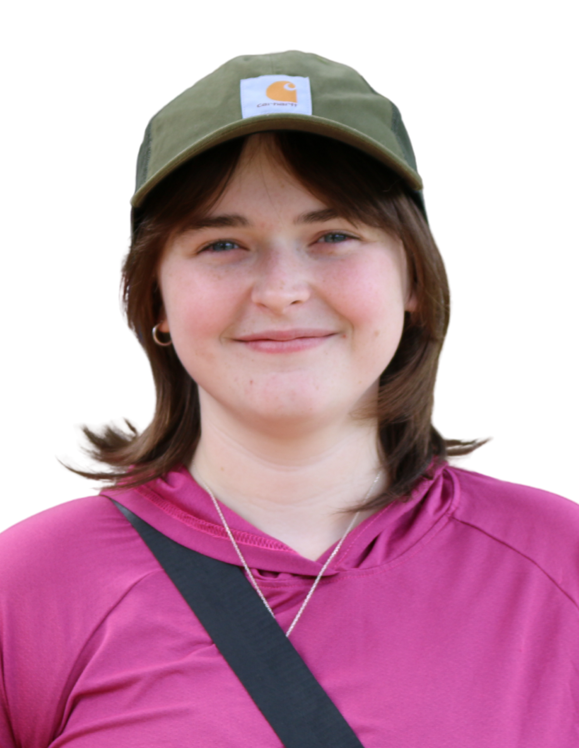 Ailish smiling while wearing a green baseball hat and pink sweater.