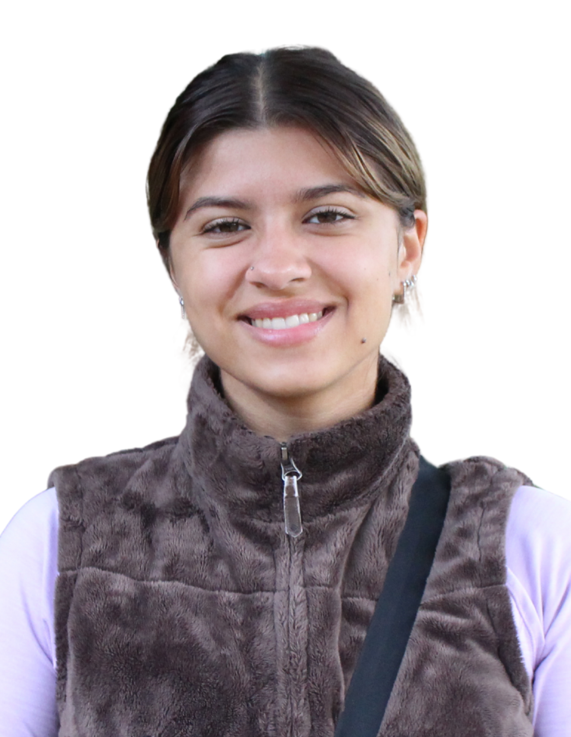 Anna smiling while wearing a brown vest and pink long-sleeved shirt.