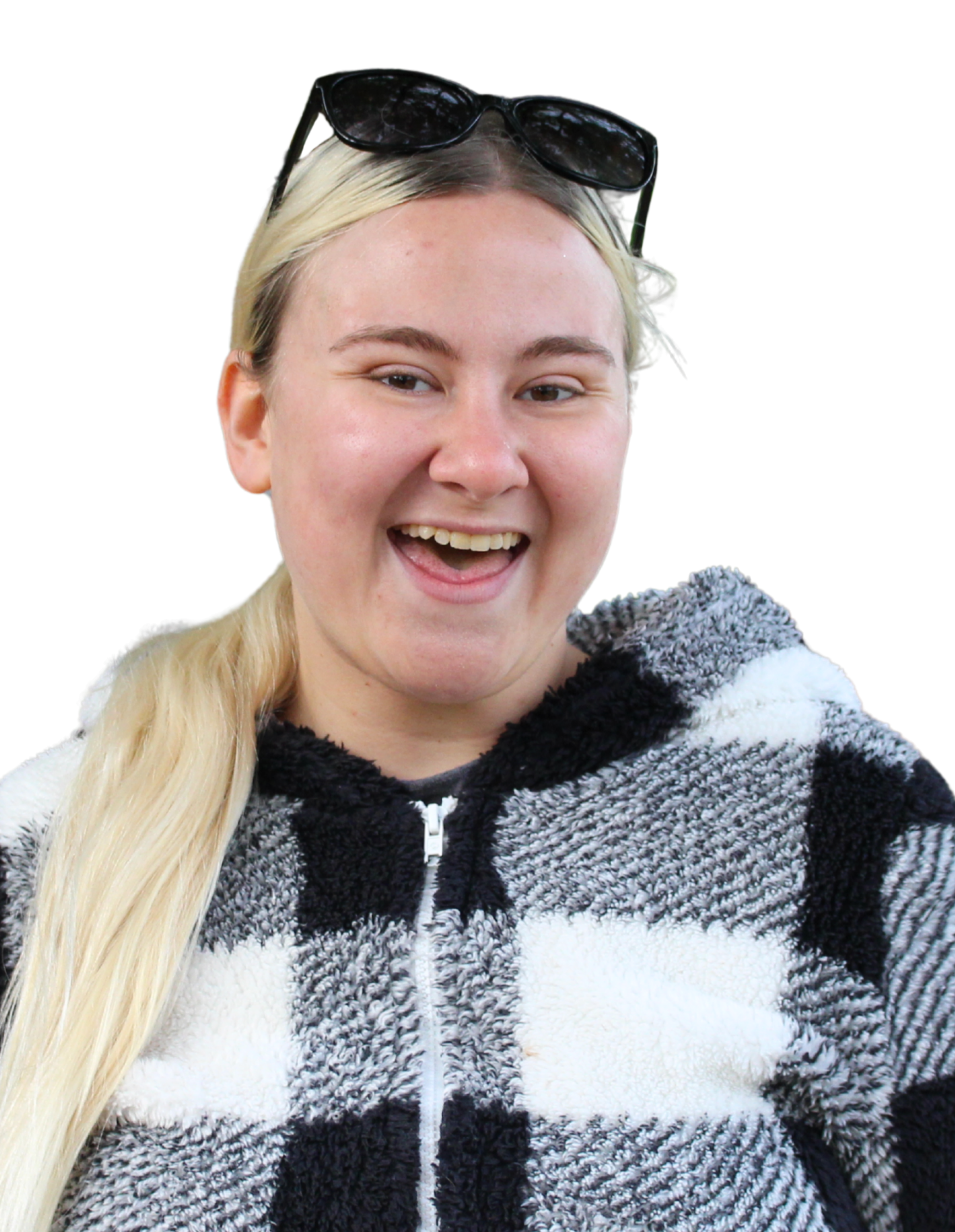 Madison smiling with sunglasses on head, wearing a black and white checked sweater.